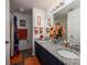 Bathroom features a double vanity with granite countertops, a shower with curtain, and orange accents at 3664 Gaston Day School Rd, Gastonia, NC 28056