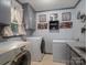 Well-lit laundry room featuring modern appliances, ample storage, and charming decor at 3664 Gaston Day School Rd, Gastonia, NC 28056