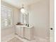 Well-lit bathroom with custom shutters, stylish lighting, and marble flooring, creating a spa-like atmosphere at 8111 Farm Crossing Ln # 2, Huntersville, NC 28078
