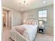 Charming bedroom featuring pastel accents, a cozy bed, and ample natural light from a large window at 8111 Farm Crossing Ln # 2, Huntersville, NC 28078