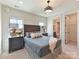 Comfortable bedroom with large windows, neutral tones, and en-suite bathroom and walk-in closet at 8111 Farm Crossing Ln # 2, Huntersville, NC 28078