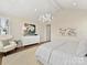 Bright bedroom with a vaulted ceiling, stylish chandelier, and neutral decor, creating a serene and elegant retreat at 8111 Farm Crossing Ln # 2, Huntersville, NC 28078