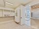 Bright walk-in closet with custom shelving, great storage solutions, and access to the bathroom at 8111 Farm Crossing Ln # 2, Huntersville, NC 28078