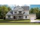 Beautifully rendered two-story home with stone accents, detailed windows, and a manicured lawn at 8111 Farm Crossing Ln # 2, Huntersville, NC 28078