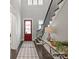 Welcoming foyer showcasing a red entry door, dark wood floors, staircase and stylish console table decor at 8111 Farm Crossing Ln # 2, Huntersville, NC 28078