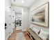 Inviting hallway with a bench, leading to a laundry room with modern washer and dryer at 8111 Farm Crossing Ln # 2, Huntersville, NC 28078
