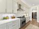 Bright, modern kitchen featuring stainless steel appliances, white cabinets, and a beautiful backsplash at 8111 Farm Crossing Ln # 2, Huntersville, NC 28078