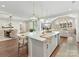 Open-concept kitchen island with quartz countertops, pendant lighting, and seating for casual dining at 8111 Farm Crossing Ln # 2, Huntersville, NC 28078