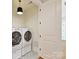 Well-lit laundry room showcasing modern appliances and stylish tiled flooring at 8111 Farm Crossing Ln # 2, Huntersville, NC 28078