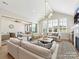 Spacious living room with vaulted ceilings, large windows, and comfortable seating for entertaining at 8111 Farm Crossing Ln # 2, Huntersville, NC 28078