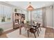 Home office with wood desk, woven light fixture, large windows, bookshelf and natural light at 8111 Farm Crossing Ln # 2, Huntersville, NC 28078