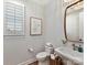 Stylish powder room with modern fixtures, a decorative mirror, and natural light, perfect for guests at 8111 Farm Crossing Ln # 2, Huntersville, NC 28078