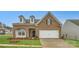 Brick two-story house with a two-car garage and landscaped lawn at 4450 Doyle Ridge Rd, Maiden, NC 28650