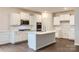 Modern kitchen with white cabinets and a large island at 4450 Doyle Ridge Rd, Maiden, NC 28650