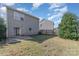 View of the back of the house and fenced backyard at 4803 Roxfield Ln, Charlotte, NC 28215