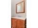 Bathroom vanity with a wood cabinet, countertop, and mirror at 4803 Roxfield Ln, Charlotte, NC 28215