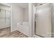 Bathroom featuring a shower stall, soaker tub and closet at 4803 Roxfield Ln, Charlotte, NC 28215