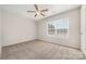 This bedroom features neutral carpet and a bright window at 4803 Roxfield Ln, Charlotte, NC 28215