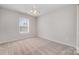 This bedroom features neutral carpet, a ceiling fan and a bright window at 4803 Roxfield Ln, Charlotte, NC 28215