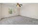 Spacious bedroom with carpet, ceiling fan, and natural light from two windows at 4803 Roxfield Ln, Charlotte, NC 28215