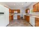 Functional kitchen featuring wood cabinetry, white appliances, and ample counter space at 4803 Roxfield Ln, Charlotte, NC 28215