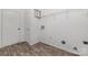 Practical laundry room with wood-look flooring and a wire shelving unit at 4803 Roxfield Ln, Charlotte, NC 28215