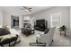 Staged living room featuring a fireplace, ceiling fan, and plenty of natural light at 4803 Roxfield Ln, Charlotte, NC 28215