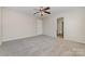 Main bedroom featuring carpet, ceiling fan, and an attached bathroom at 4803 Roxfield Ln, Charlotte, NC 28215