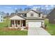 Two-story house with stone accents and a white garage door at 9916 Manor Vista Trl, Kannapolis, NC 28027