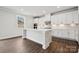 Modern kitchen featuring white cabinets, a center island, stainless appliances, and hardwood floors at 9916 Manor Vista Trl, Kannapolis, NC 28027