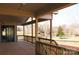 Relaxing back porch with wood railing featuring views of a serene lake and lush greenery at 104 Arbor Dr, Waxhaw, NC 28173