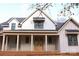 Charming new construction home featuring a covered front porch and double front doors at 104 Arbor Dr, Waxhaw, NC 28173