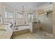 Large bathroom with soaking tub, walk-in shower, and double vanity at 17929 Pages Pond Ct, Davidson, NC 28036