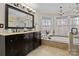 Bathroom with double vanity, soaking tub, and walk-in shower at 17929 Pages Pond Ct, Davidson, NC 28036