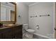 Bathroom with dark vanity, toilet, and plenty of storage at 17929 Pages Pond Ct, Davidson, NC 28036