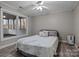 Bedroom with leafy bedding, ceiling fan, and view of a deck at 17929 Pages Pond Ct, Davidson, NC 28036