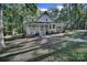 House exterior showcasing a charming white home and landscaping at 17929 Pages Pond Ct, Davidson, NC 28036