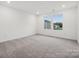 Bright bedroom with grey carpet and large window offering natural light at 311 Bezelle Ave, York, SC 29745