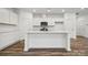 White kitchen with an island and stainless steel appliances at 311 Bezelle Ave, York, SC 29745