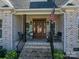 Front porch detail with wooden columns and flag at 329 Wintergreen Ct, Kings Mountain, NC 28086