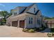 Two-car garage with decorative doors and landscaping at 329 Wintergreen Ct, Kings Mountain, NC 28086