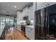 Bright kitchen featuring white cabinets, stainless steel appliances, and hardwood floors at 329 Wintergreen Ct, Kings Mountain, NC 28086