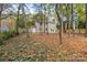 Spacious backyard with tree coverage and a large grassy area at 6920 Wyndbend Ln, Mint Hill, NC 28227