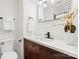 Modern bathroom with brown vanity and white countertop at 6920 Wyndbend Ln, Mint Hill, NC 28227