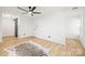 Bright bedroom with wood floors, ceiling fan, and barn door at 6920 Wyndbend Ln, Mint Hill, NC 28227