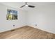 Well-lit bedroom featuring a ceiling fan and window at 6920 Wyndbend Ln, Mint Hill, NC 28227