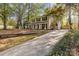 Long driveway leading to a two-story house with a landscaped yard at 6920 Wyndbend Ln, Mint Hill, NC 28227