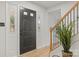 Modern entryway with dark wood floors and a black front door at 6920 Wyndbend Ln, Mint Hill, NC 28227