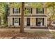 Two-story house with beige siding, black shutters, and a covered porch at 6920 Wyndbend Ln, Mint Hill, NC 28227