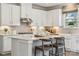 Modern white kitchen with island, stainless steel appliances, and white shaker cabinets at 9912 Manor Vista Trl, Kannapolis, NC 28027